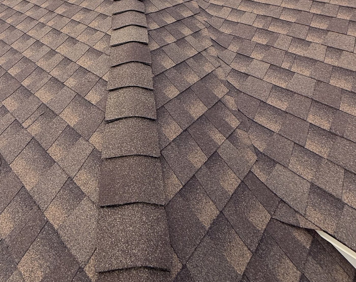 Close-up of finished ridge cap shingle detail and coursing