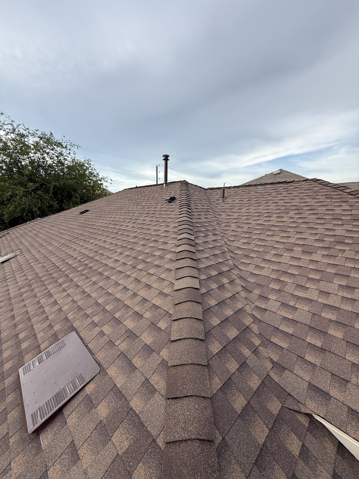 Close-up of a finished shingle roof ridge line