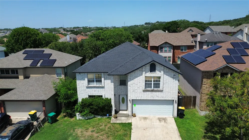Aerial street view of homes with completed roofs