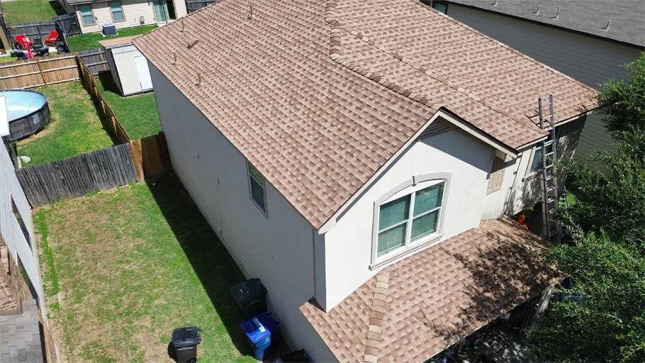 Aerial view of a completed roof, home with a pool