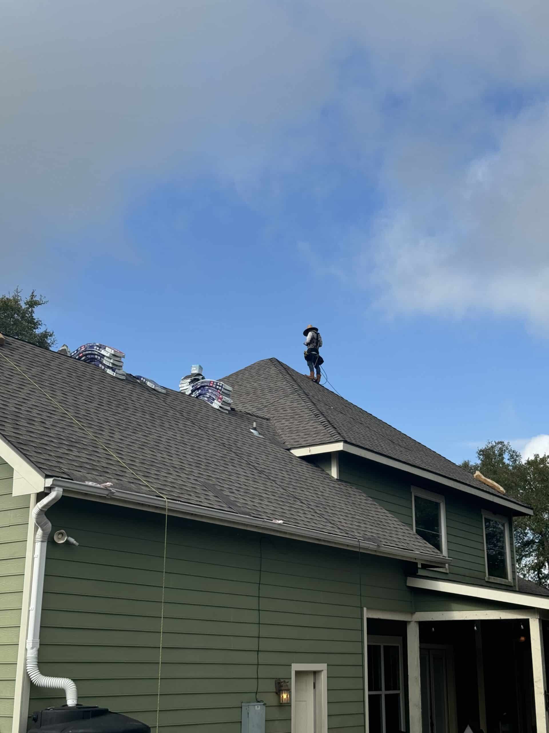 Aerial view of a roof with a crew member visible