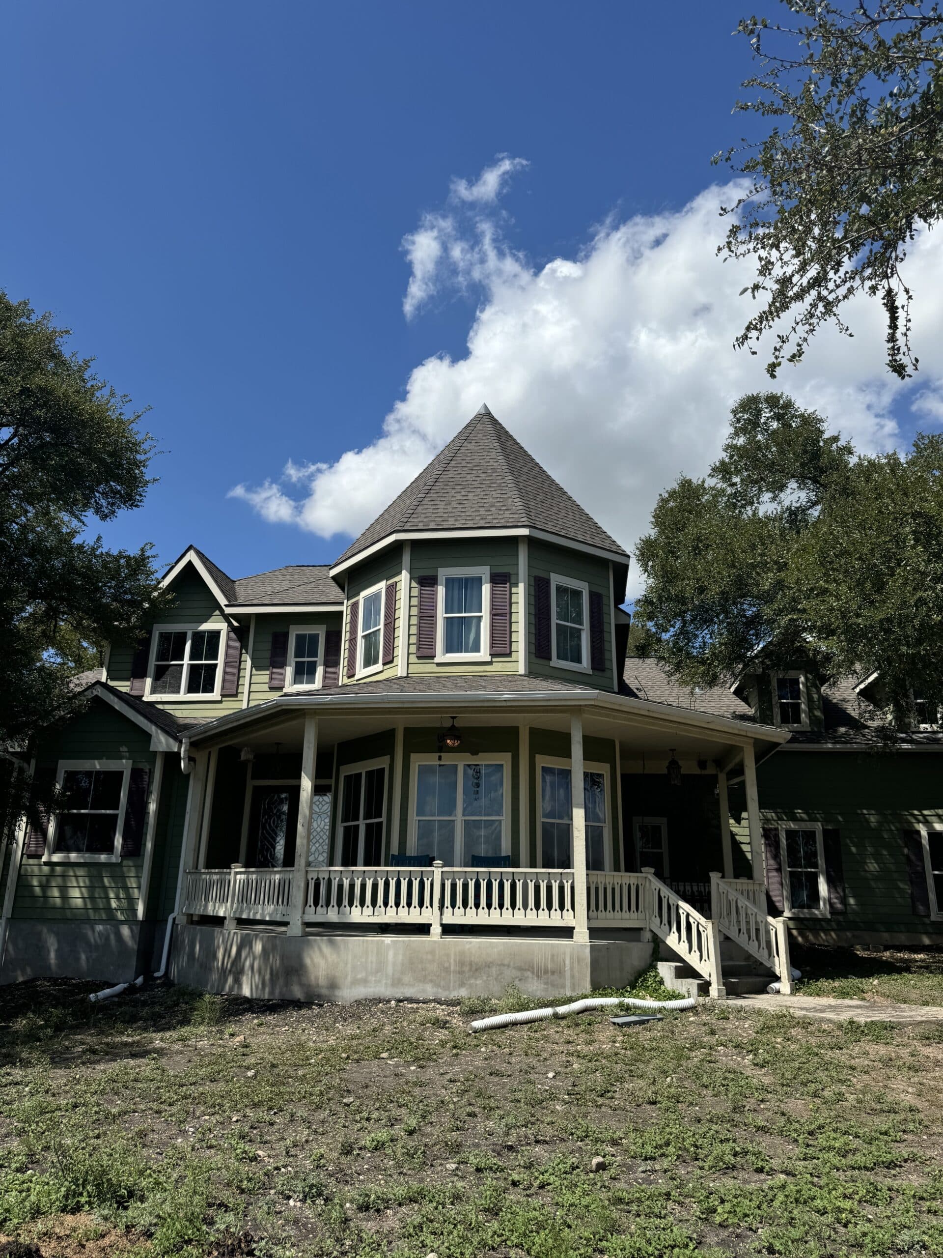 Completed roof on a home with a wraparound porch
