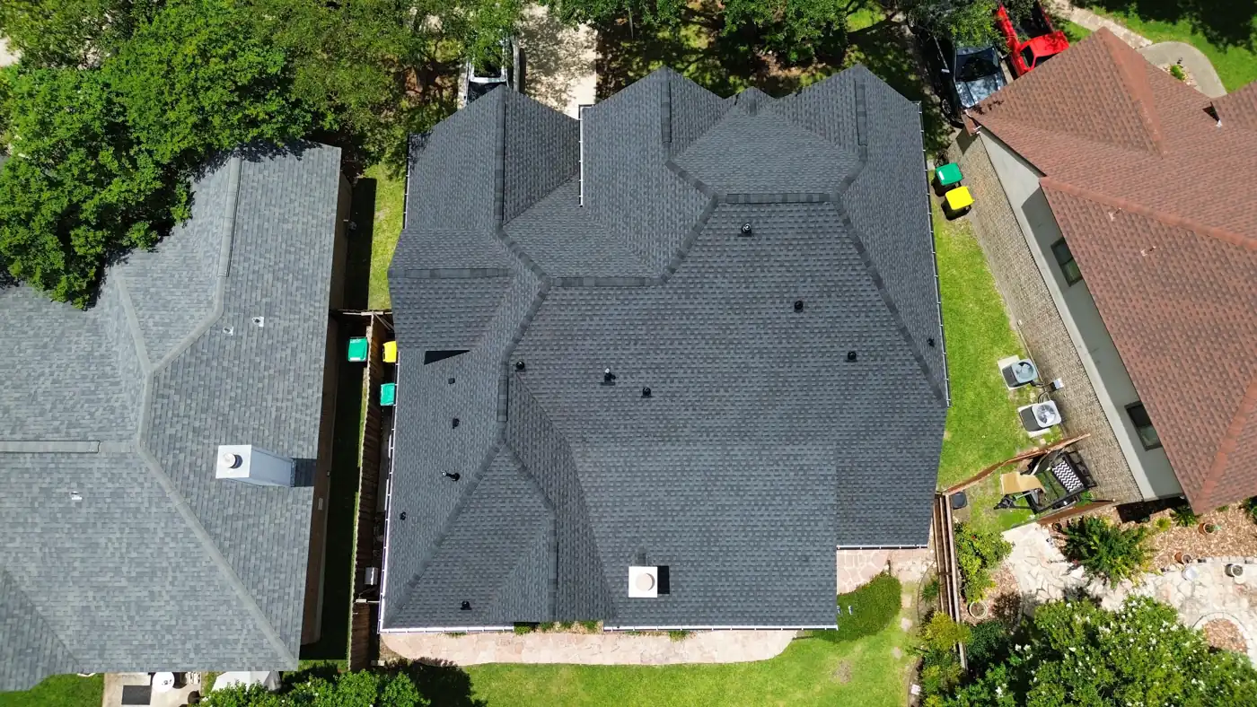 Top-down drone view of a finished hip-and-valley architectural shingle roof in Helotes, TX, June 2025