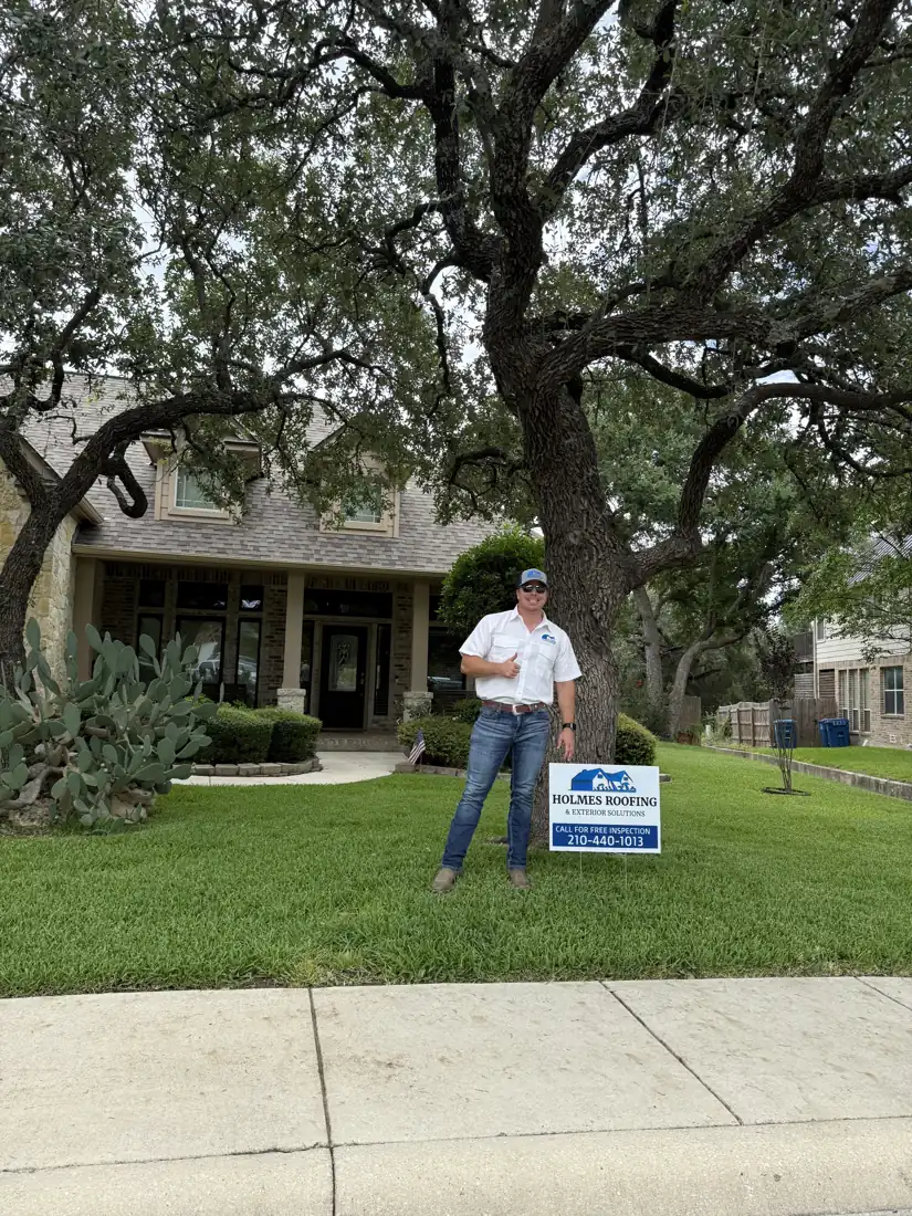 Holmes Roofing & Exterior Solutions yard sign in front of a completed roof replacement in the Stone Oak area of San Antonio, TX, July 2025