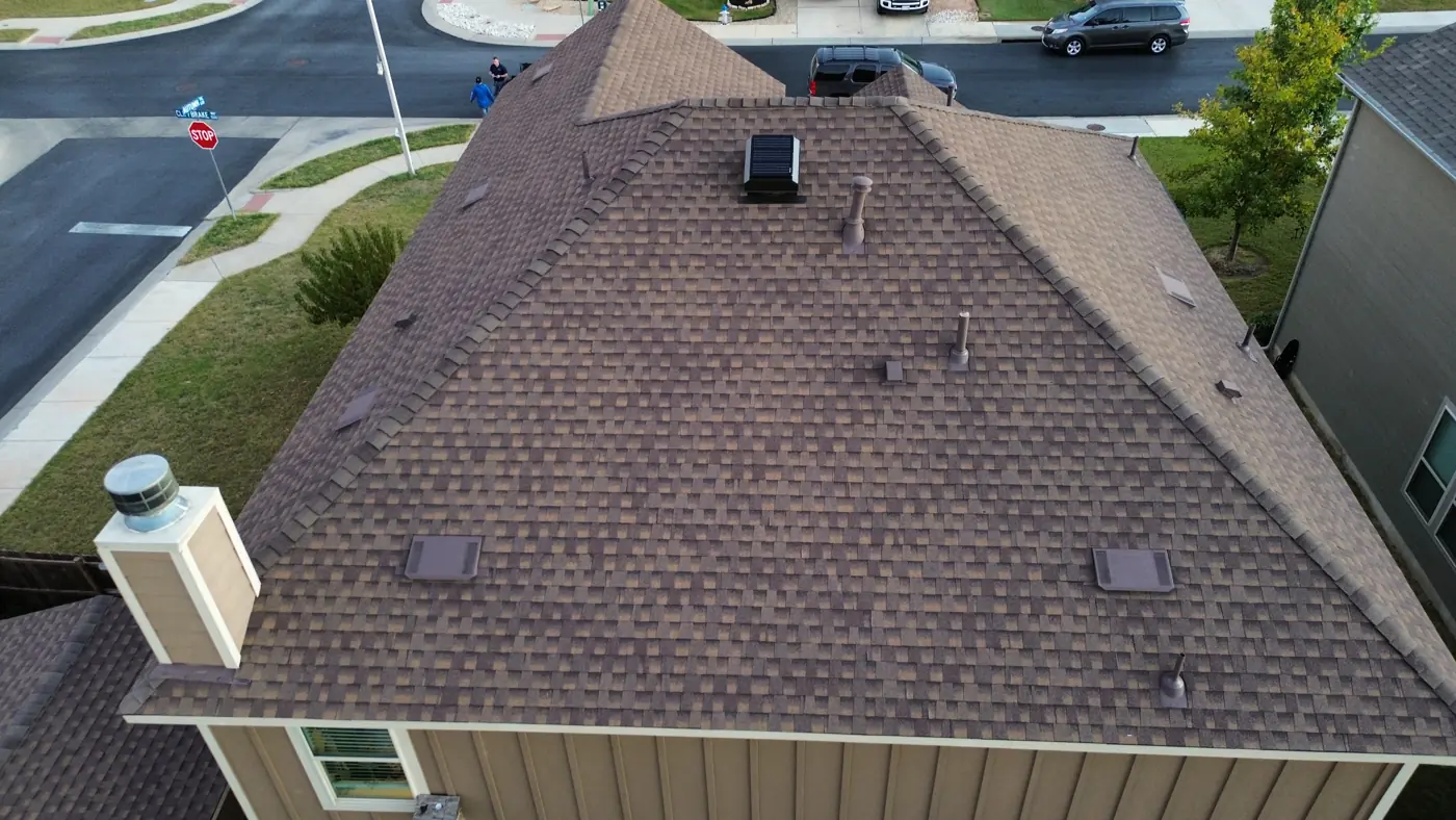 Drone aerial of a completed architectural shingle roof replacement on a corner-lot home in Georgetown, TX by Holmes Roofing & Exterior Solutions, November 2025