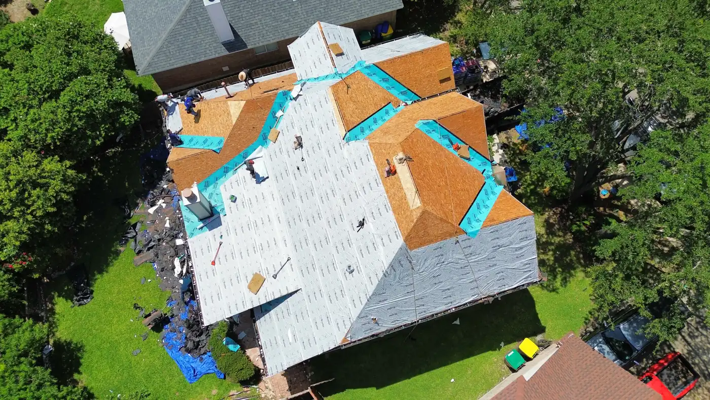 Aerial view of the Holmes Roofing crew mid-installation on a complex roofline in Helotes, TX, June 2025