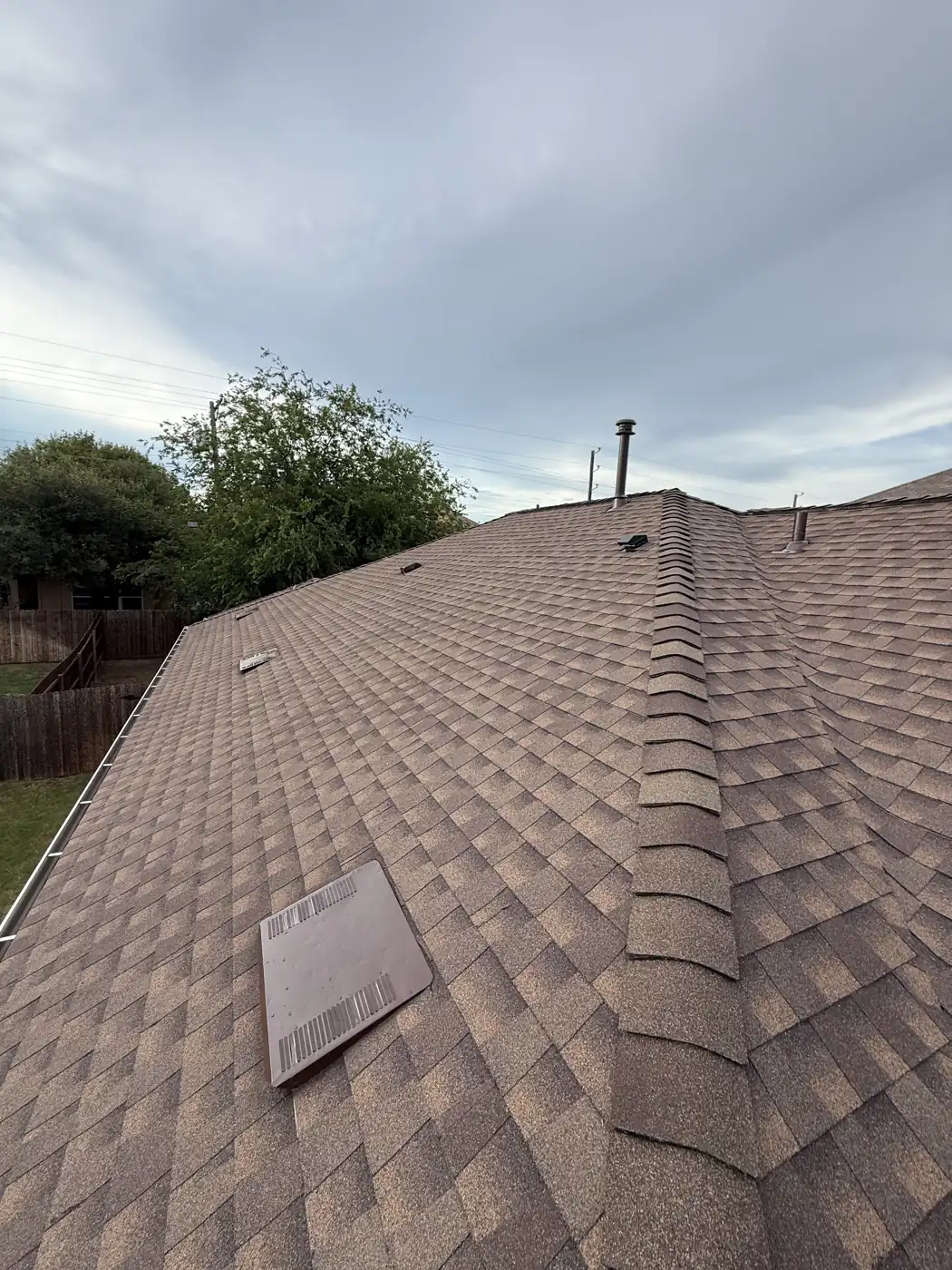 Full roof slope of a new architectural shingle installation with completed hip and flashing work in Georgetown, TX, June 2025
